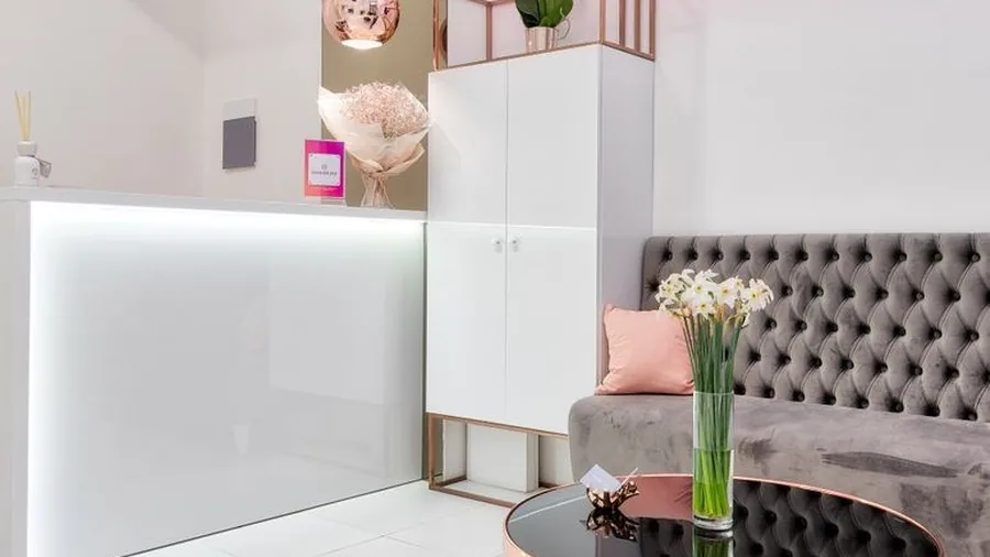 Elegant reception foyer of a modern clinic with seating and flowers
