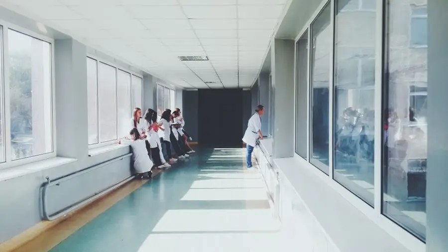 Bright modern clinic corridor with medical staff