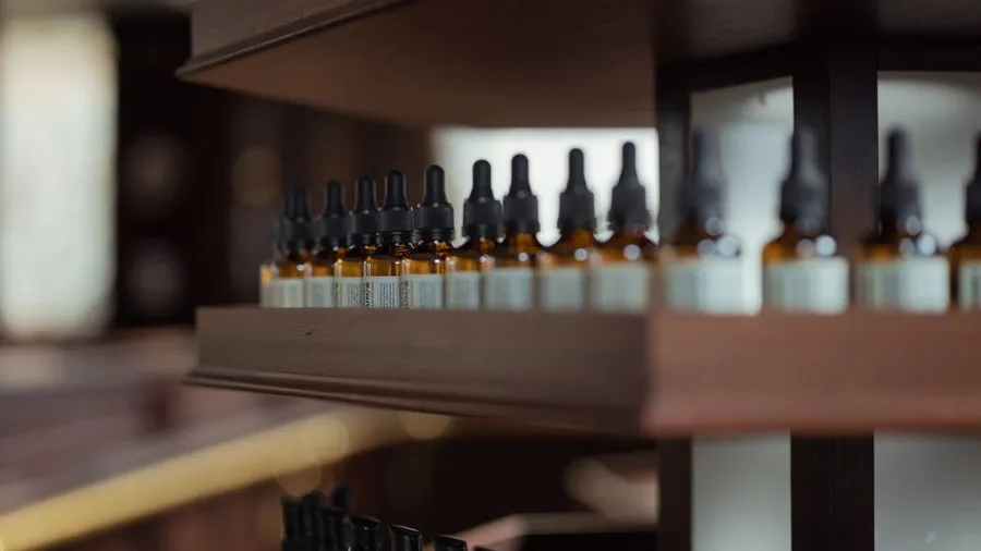 Shelf of dropper bottles in a skincare shop