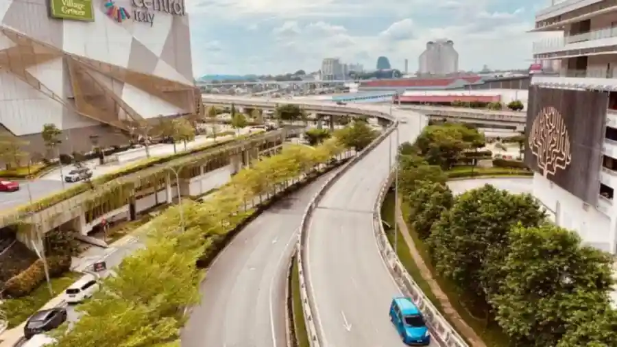 Highway and elevated road running past a shopping mall in the Klang Valley