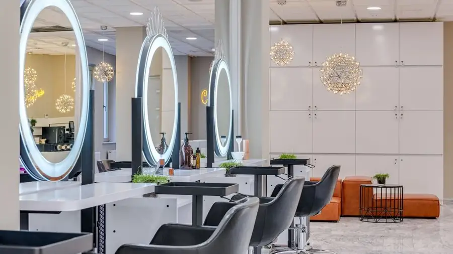 Bright modern hair salon interior with mirrors and styling chairs