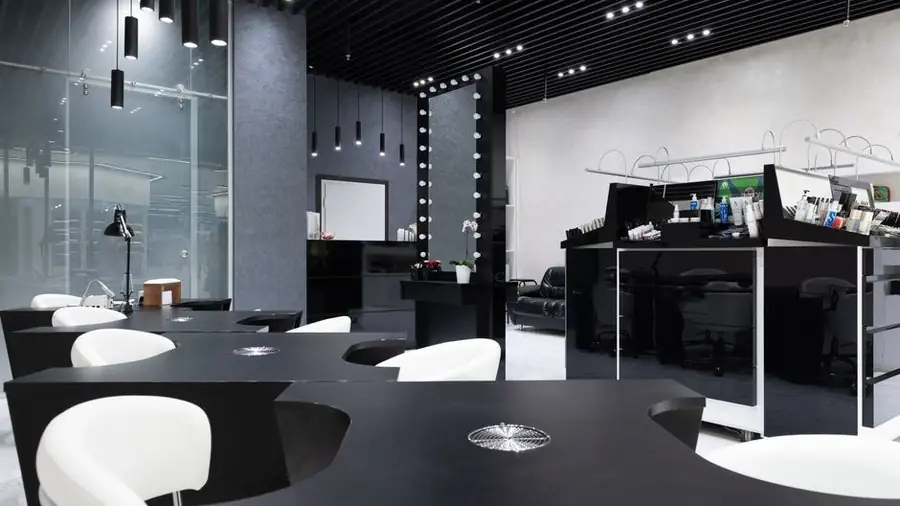 Interior of a modern nail salon with styling stations and mirrors