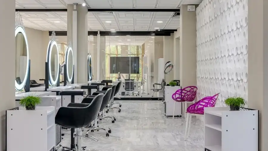 Bright salon interior with styling mirrors, chairs and a clean workstation