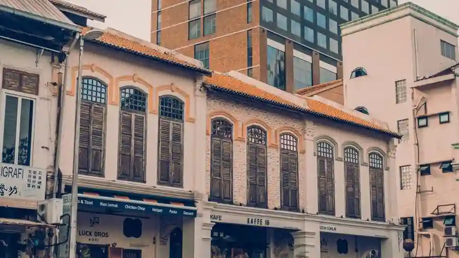Row of shophouse cafes and boutiques on a tree-lined Bangsar street in Kuala Lumpur