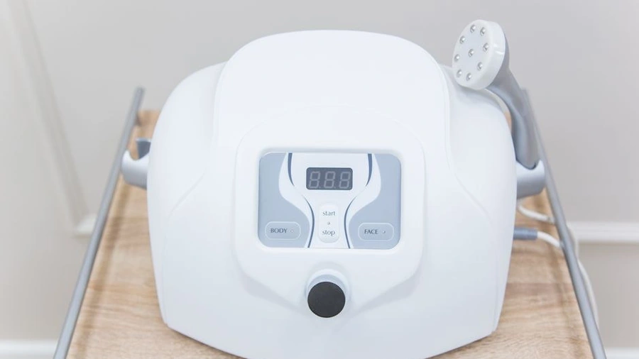 Close-up of an aesthetic treatment device on a clinic cart