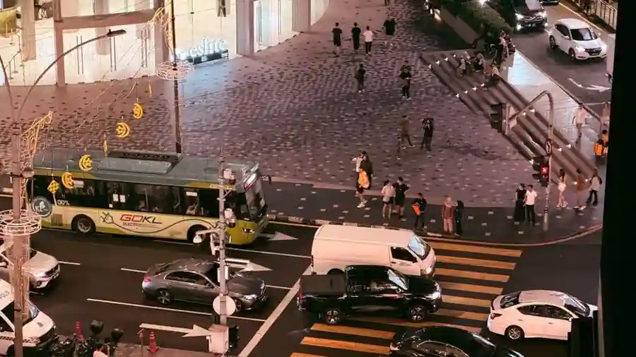 City street intersection with traffic at night