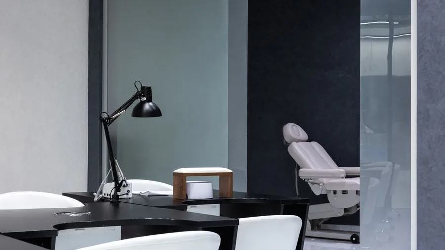 Minimalist beauty salon interior with treatment chair and desk lamp