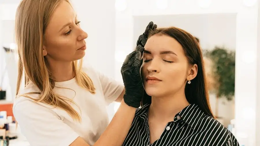 Beauty studio brow bar interior with a client having eyebrows shaped