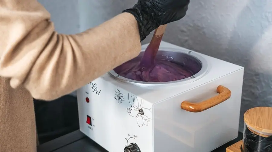 Close-up of wax being prepared in a heated wax pot