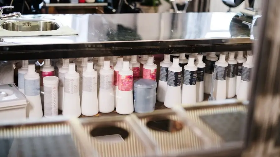 Salon shelves stocked with hair colour and care products
