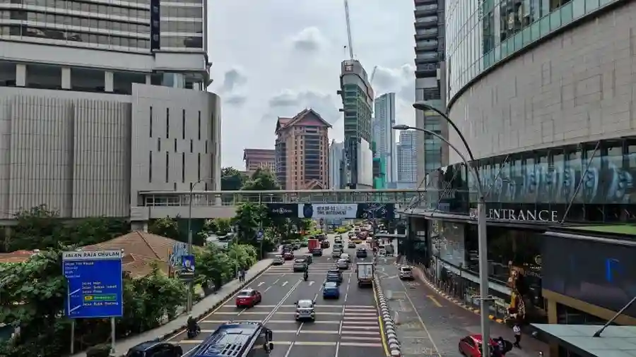 Busy Kuala Lumpur road with high-rises and an overpass