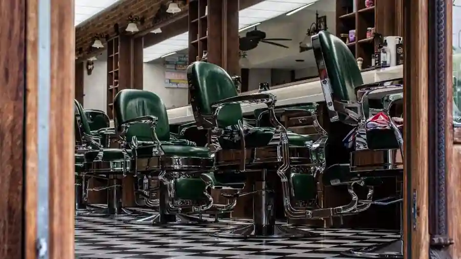 Vintage barber shop with classic green chairs and mirrors