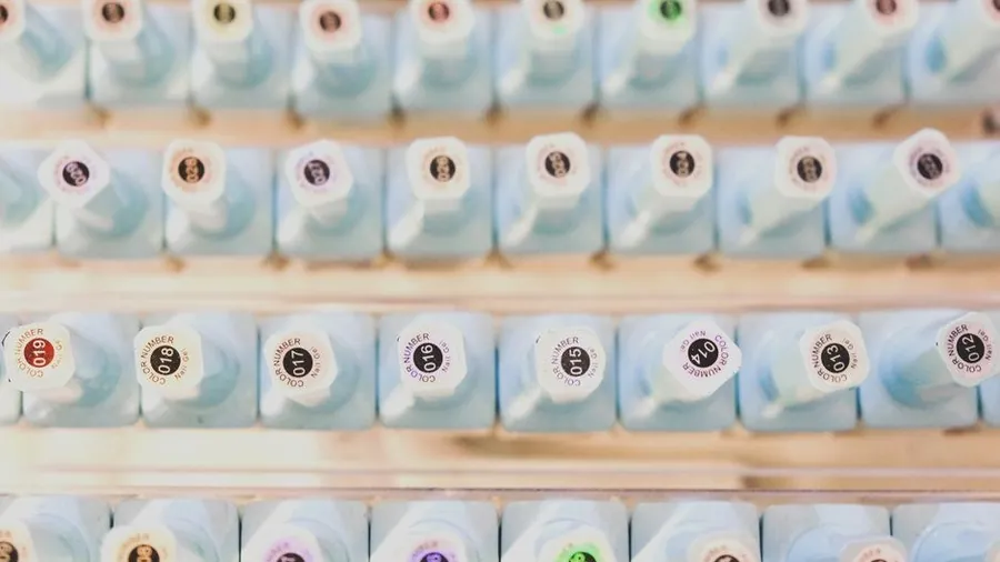 Rows of gel polish bottles on a salon shelf