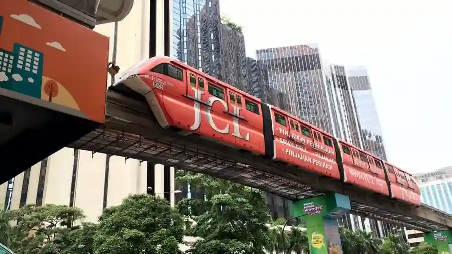 Monorail train running above a tree-lined street in central Kuala Lumpur