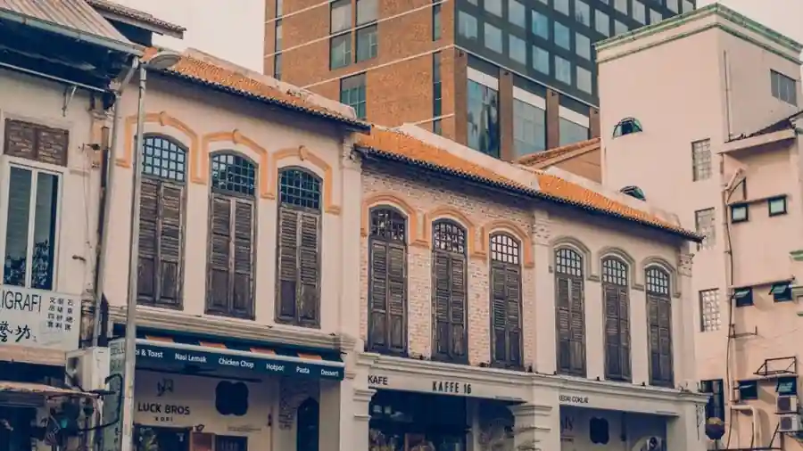 Row of two-storey shophouses with ground-floor retail units on a Malaysian street