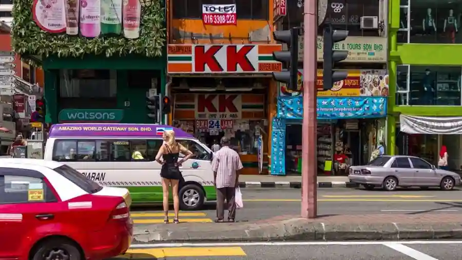 Malaysian street lined with ground-floor shoplots and retail signage
