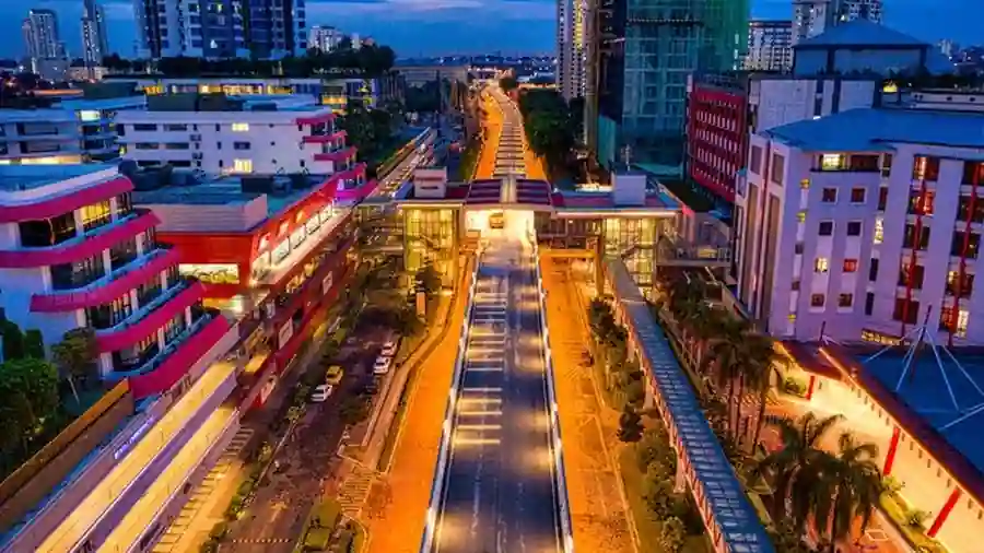 Aerial night view of a Malaysian commercial district with illuminated streets