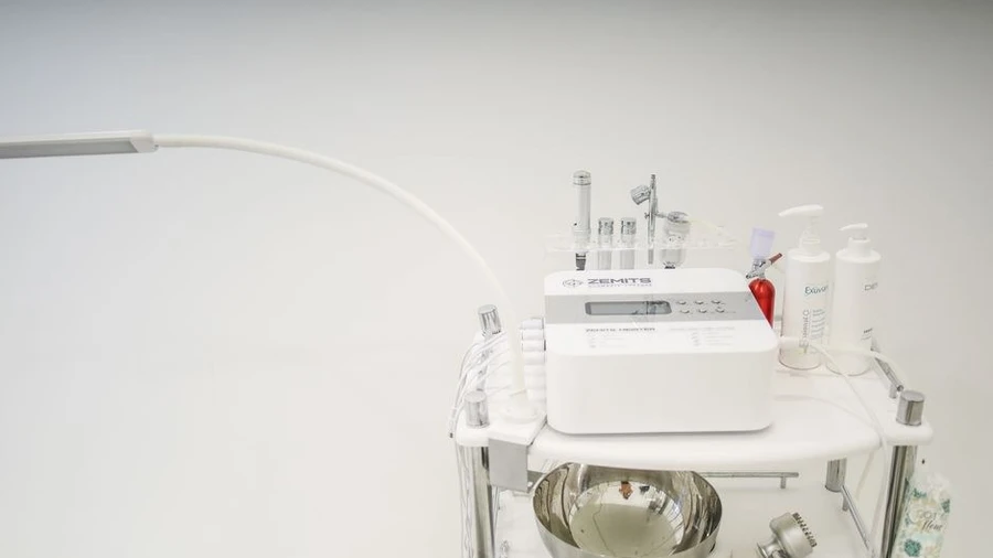 Skincare treatment cart with device and supplies in a clinic room