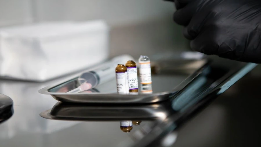 Syringes and vials laid out on a clean tray for an injectable treatment