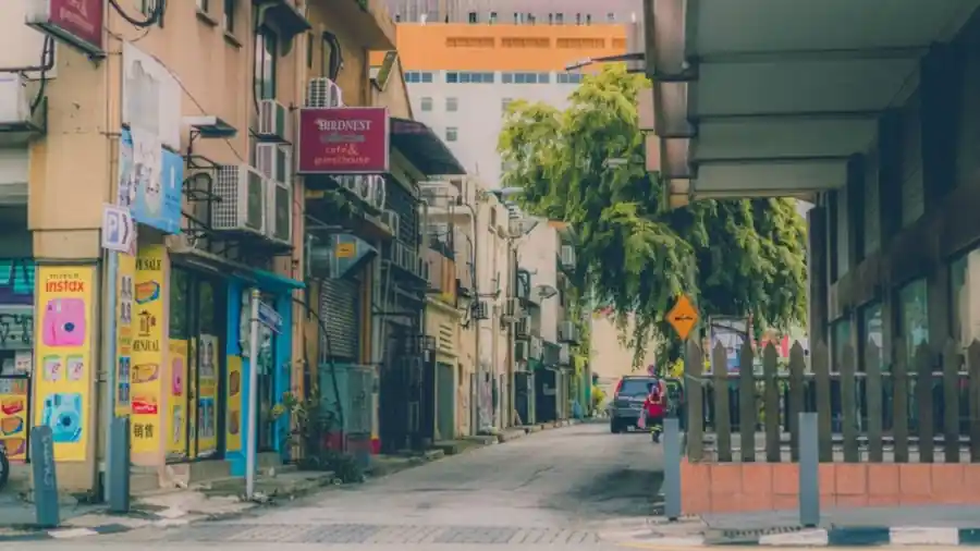 Row of neighbourhood shoplots on a Kuala Lumpur street with signage
