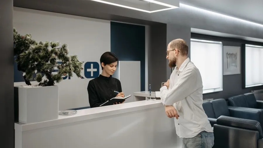 Reception counter of a modern skin clinic with seating and plants