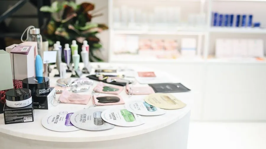 Skincare and spa retail display with jars, tubes and sample sachets on a table