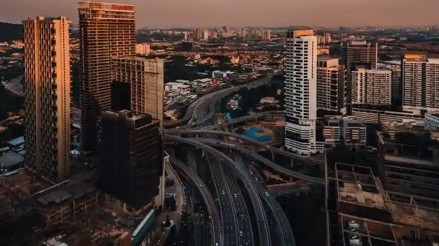 Aerial view of Petaling Jaya towers and highway interchange at dusk