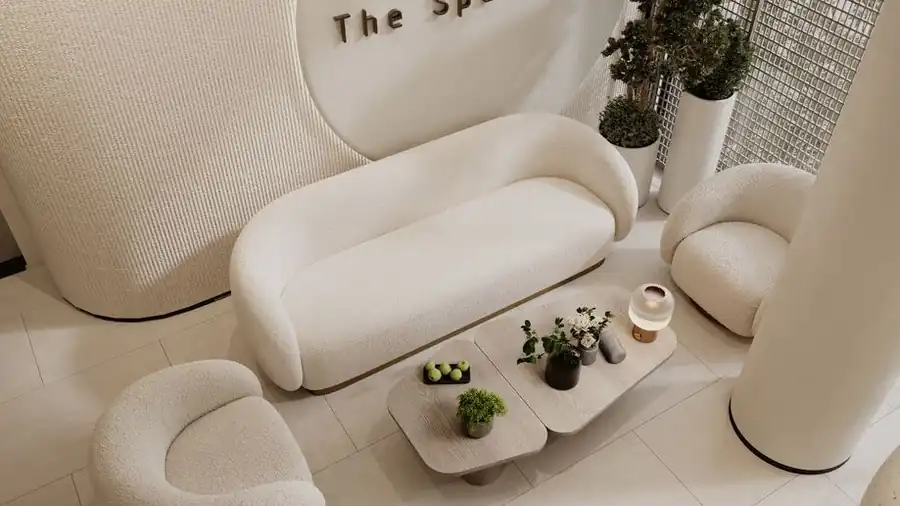 Minimalist spa waiting area with cream sofas and greenery