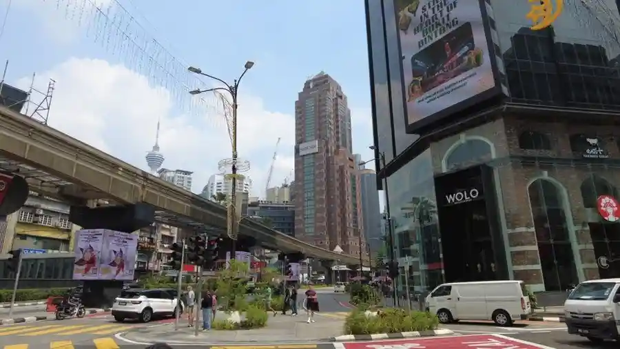 Busy street scene in Bukit Bintang with shopping mall signage and traffic