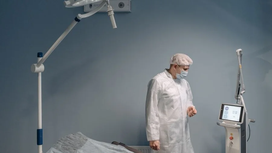 Operating room with surgical light and prepared bed at a private clinic