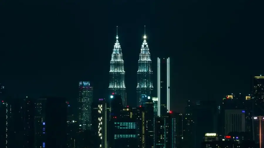 Kuala Lumpur city skyline at night with illuminated towers
