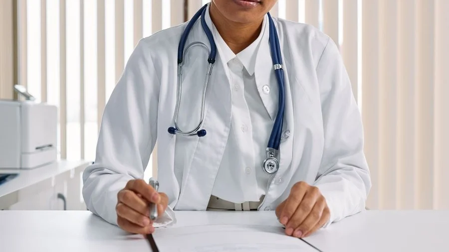 Doctor reviewing a patient chart during a clinic consultation