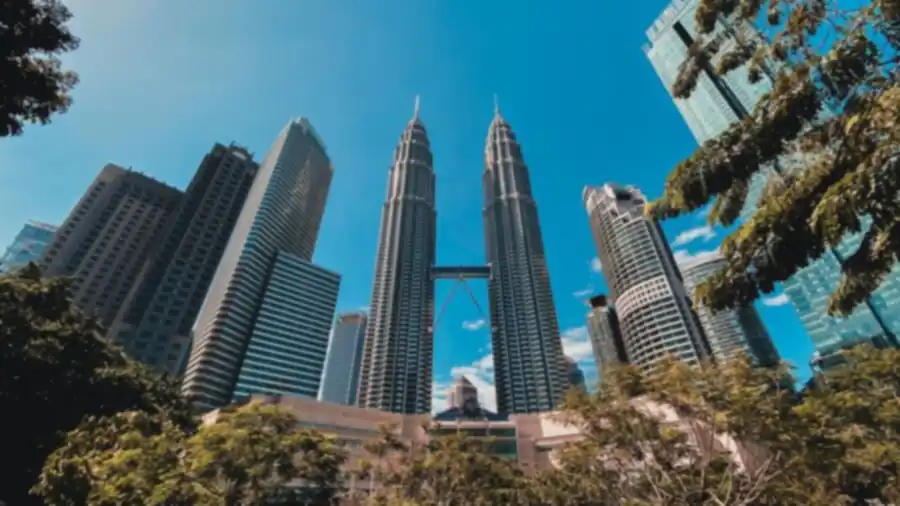 Petronas Towers seen from below against a blue sky in Kuala Lumpur