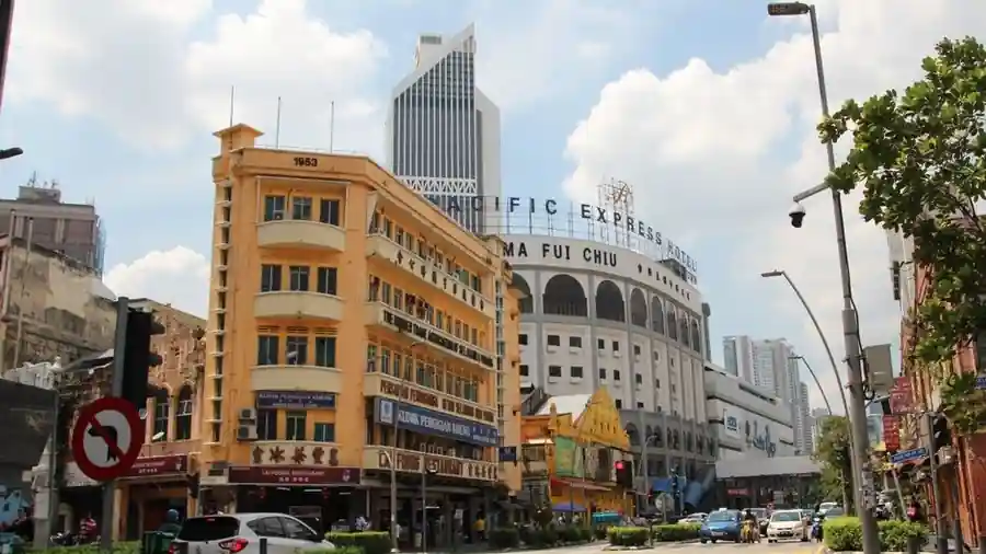 Street of historic shophouses and modern towers in central Kuala Lumpur