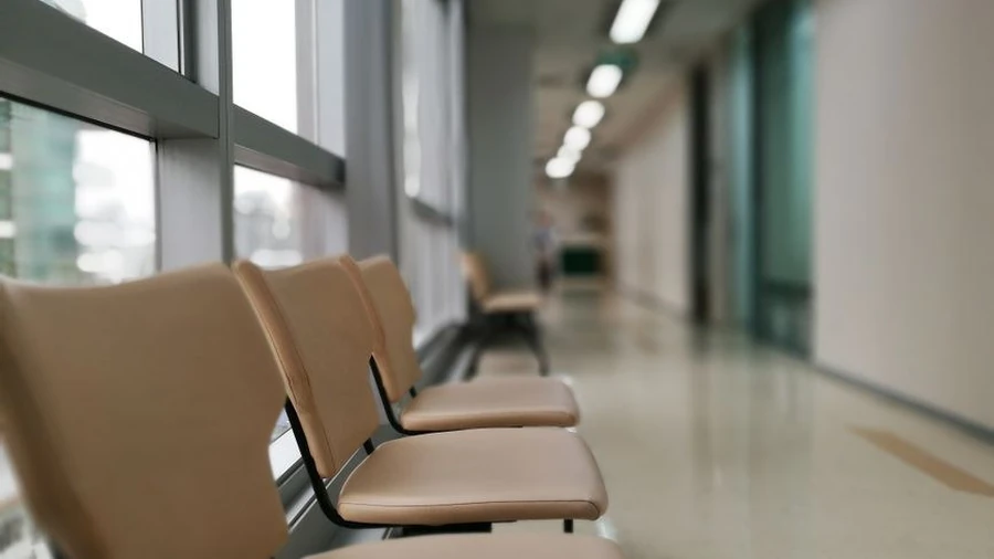 Empty seating area inside a Malaysian medical facility corridor