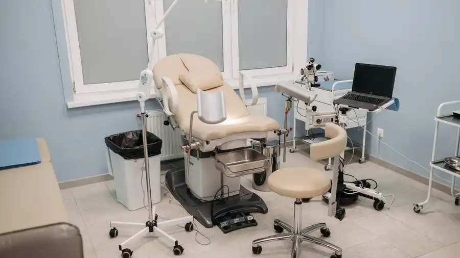 Clean equipped medical consultation room with an examination chair