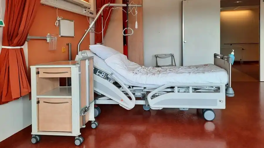 Empty modern hospital room with an adjustable bed
