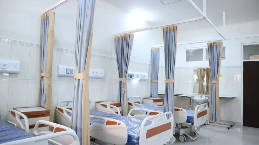 Private hospital ward with curtained patient beds