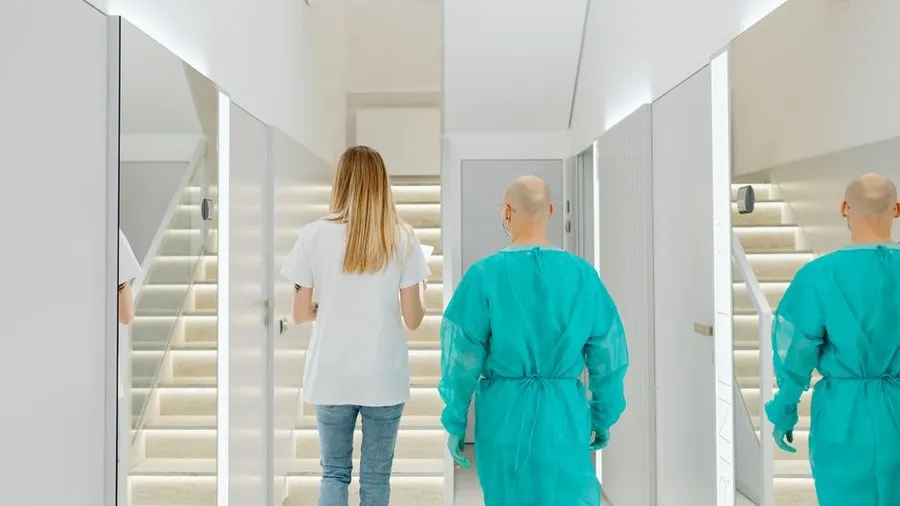 Clinic staff walking down a bright hallway between treatment rooms