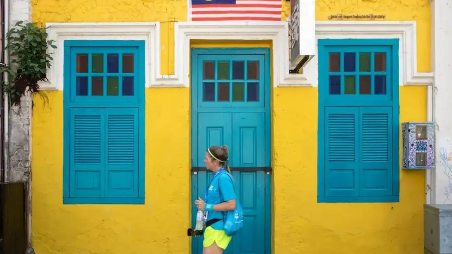 Yellow heritage shophouse with blue shutters