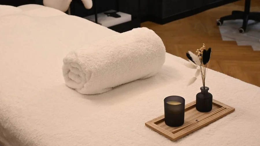 Treatment bed with rolled towel in a quiet clinic room
