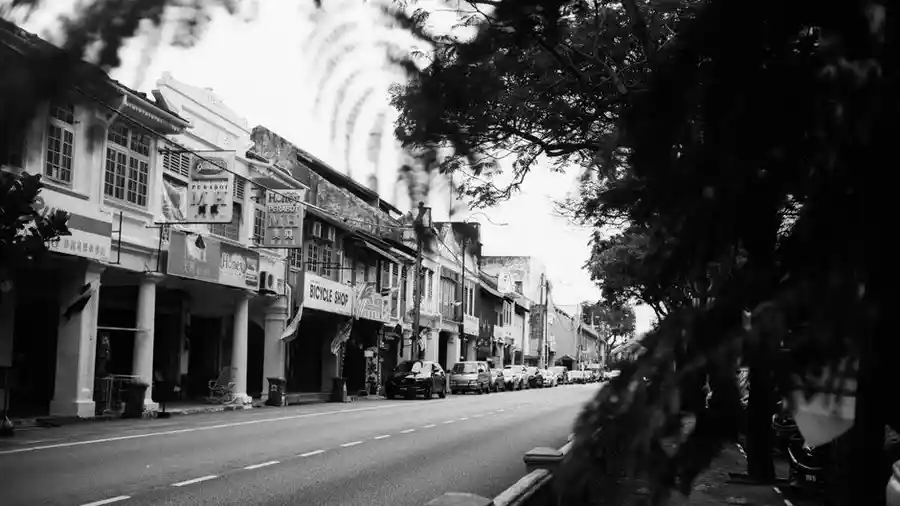 Black and white view of an older shophouse street in Malaysia