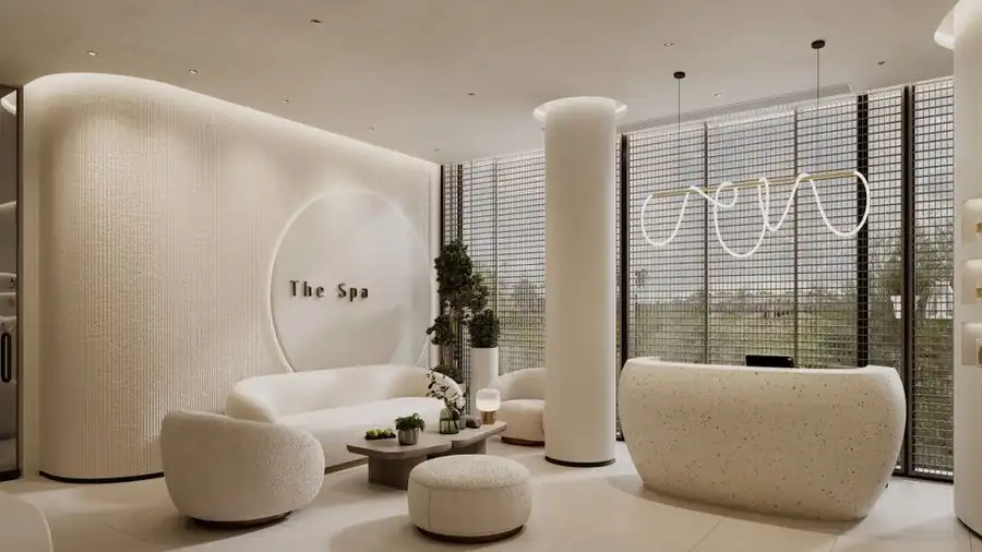 Minimalist spa waiting area with curved cream furniture and soft daylight