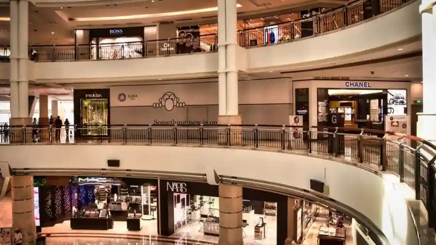 Interior walkway of a Kuala Lumpur shopping mall with retail units on two levels