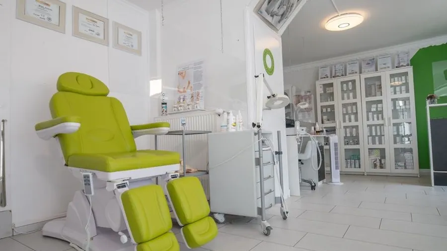 Modern aesthetic clinic treatment room with green accent wall